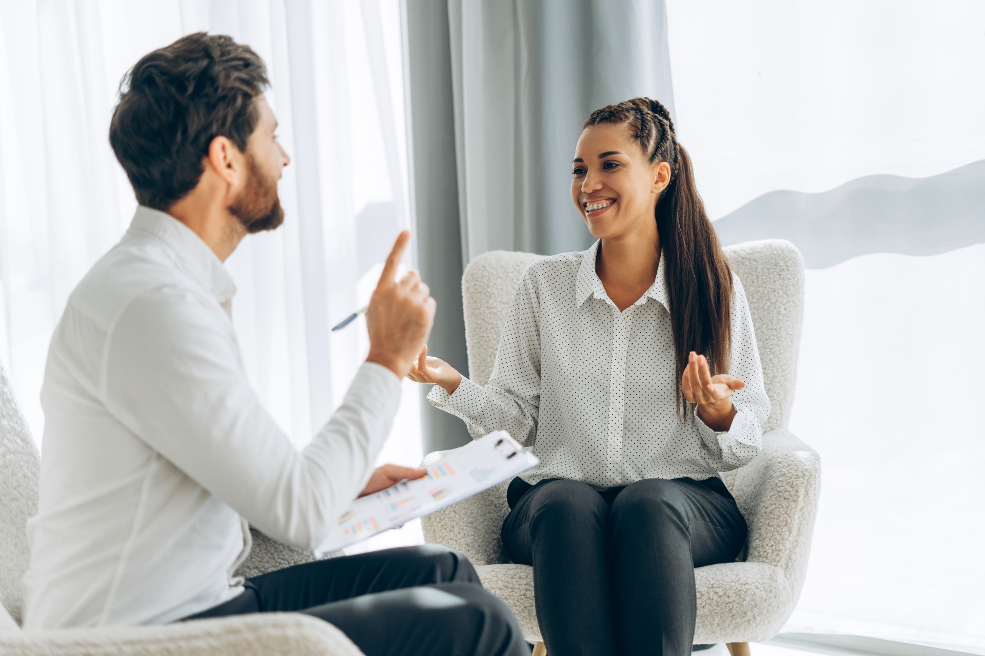 Portrait of happy, smiling professional doctor, psychologist talking with attractive woman Portrait of happy, smiling professional doctor, psychologist talking with attractive woman